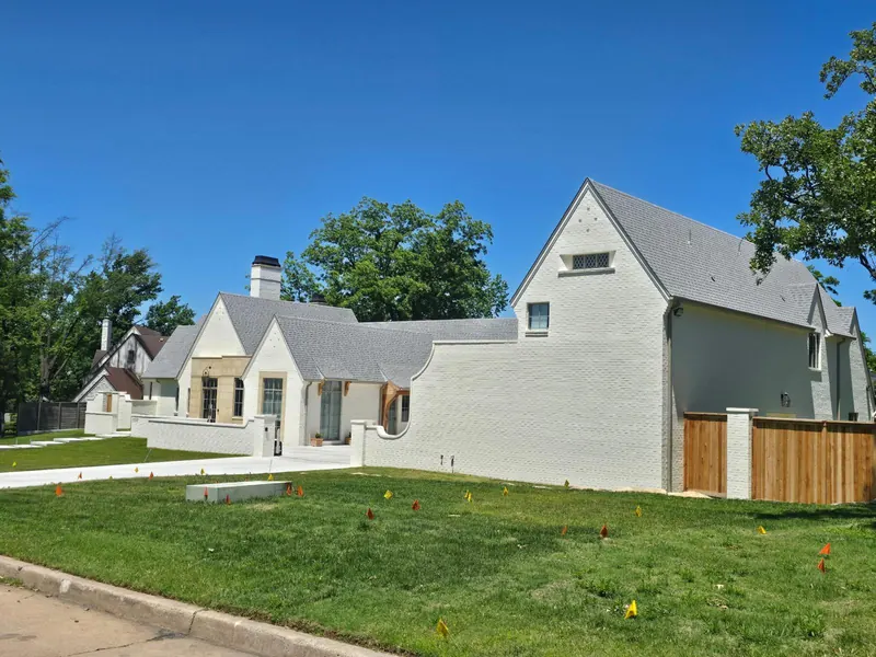 Exterior of a home with freshly painted white brick